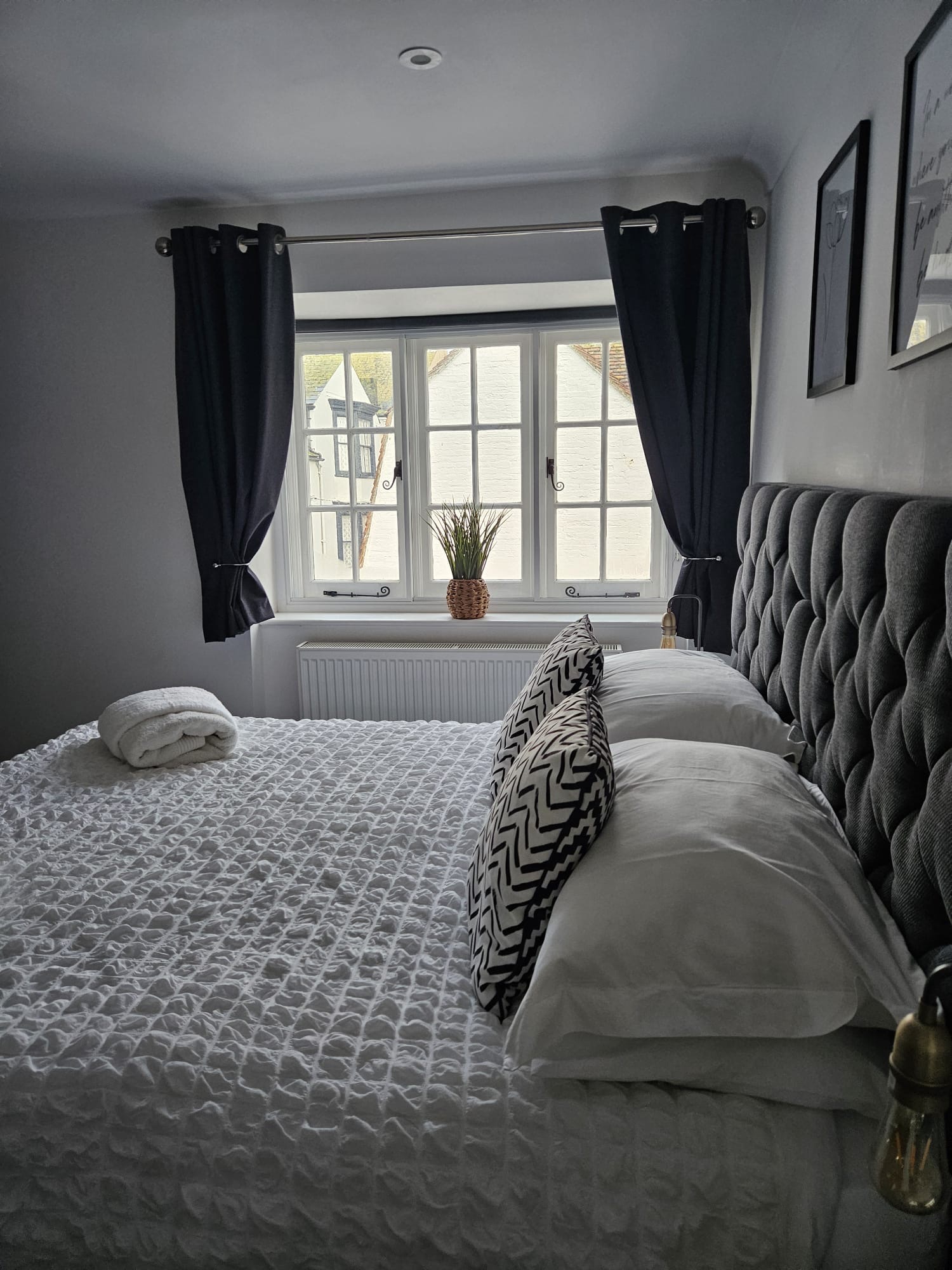 Bedroom with dresser, Smart TV and original fireplace at The Escape